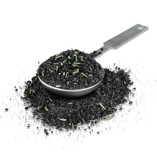 Fire & Smoke Society F&S Black and Tan Seasoning Blend, black and green seasoned spice mix in a metal scoop with some spilled onto a black surface.