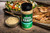 Fire & Smoke Society F&S RODEO RANCH CHICKEN RUB 9.5 OZ, spice rub container for grilling and barbecue on a wooden table with cooked chicken, salad, and grilled vegetables in the background.