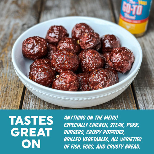 Fire & Smoke Society F&S | THE GO-TO 6.7OZ, image of cooked meatballs in a white bowl on a wooden surface with seasoning and a container in the background.