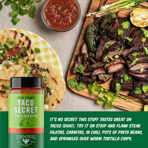 Fire & Smoke Society F&S Tommy Taylor's Taco Secret Taco Seasoning 9.2 oz, bottle of taco seasoning with a vibrant green label, placed next to grilled meats, tortillas, and fresh cilantro on a rustic table setting.