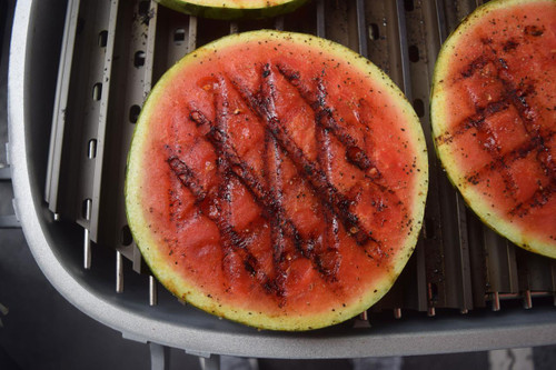 GrillGrate® for PK360, grilled watermelon slices with grill marks on a barbecue grill.