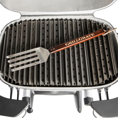 GrillGrate® for PK360, stainless steel grilling grate with elevated ridges, included with a wooden-handled spatula labeled GrillGrate for outdoor barbecue grilling.