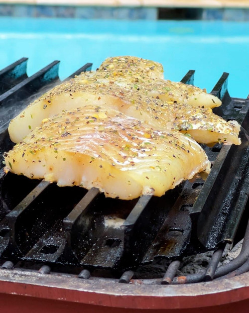 GrillGrate® for The Original & PK300 Grill, seasoned chicken breasts cooking on the grill with spice and herb seasoning.