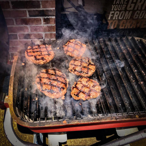 GrillGrate® for The Original & PK300 Grill, outdoor grill with sizzling burger patties featuring char marks and smoke.