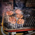 GrillGrate® for The Original & PK300 Grill, outdoor grill with sizzling burger patties featuring char marks and smoke.