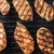 GrillGrate® for The Original & PK300 Grill, grilled chicken breasts with distinct grill marks on a black grill grate.