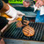 GrillGrate® for The Original & PK300 Grill, close-up of a cooking grate with grilled steaks being prepared, showing grill marks and over direct heat.