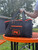 PK Grills PKGO Carrying Bag, black nylon carrying case with orange zippers and logo for portable grills.
