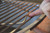 PK Grills Stainless Steel Cooking Grid & Charcoal Grate for Original PK, close-up of a hand cleaning the stainless steel cooking grid and charcoal grate for a PK grill.
