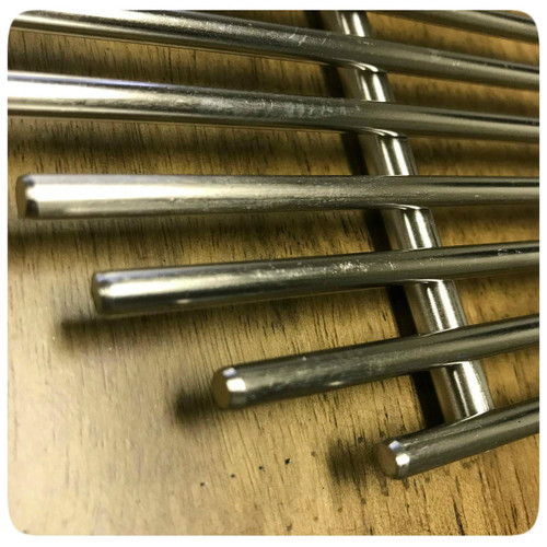 PK Grills Stainless Steel Cooking Grid & Charcoal Grate for Original PK, close-up image of stainless steel cooking grid and charcoal grate for PK grill on a wooden surface.