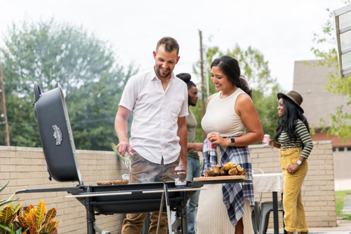 PK Grills The All New Original PK300AF Grill & Smoker - Coal, people enjoying outdoor barbecue with friends and family.