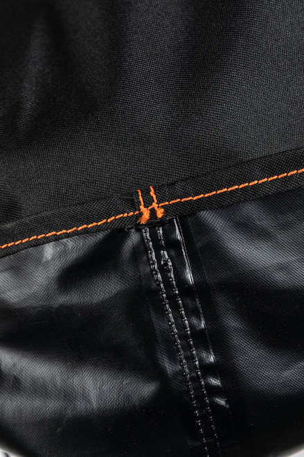 PK Grills The All New PK360 Slim Cover, close-up of durable black fabric with orange-stitch detailing.
