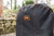 PK Grills The NEW PK300 Slim Cover, black grill cover with orange stitching and PK logo for outdoor barbecue protection.