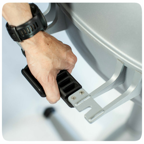 PK Grills The PK360 Grill & Smoker - Classic Silver, close-up of a person's hand adjusting the temperature control valve on the outdoor grill.