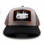 PK Pig Hat Ash Grey, structured baseball cap with a black brim, grey front panels, and mesh side panels, featuring a patch with a white pig illustration and orange border.