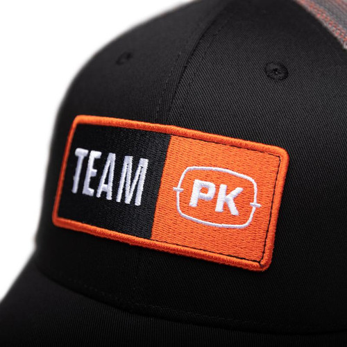 PK Team PK Hat, black cap with orange and white embroidered patch featuring 'TEAM' and 'PK' logos.