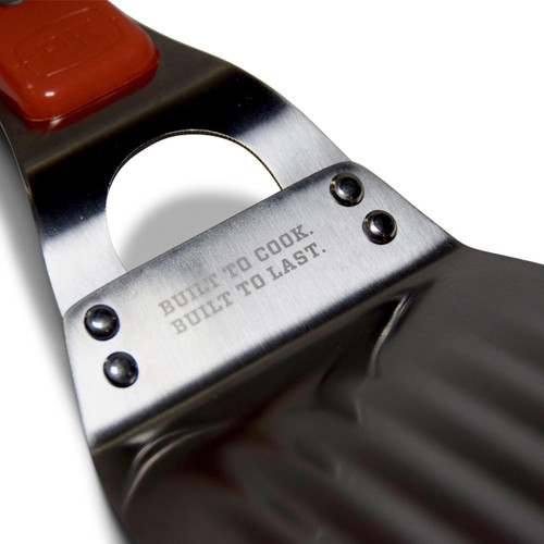 The Stainless Steel PK Spatula, a durable and high-quality kitchen tool with an engraved slogan 'Built to Cook. Built to Last.' on the handle.